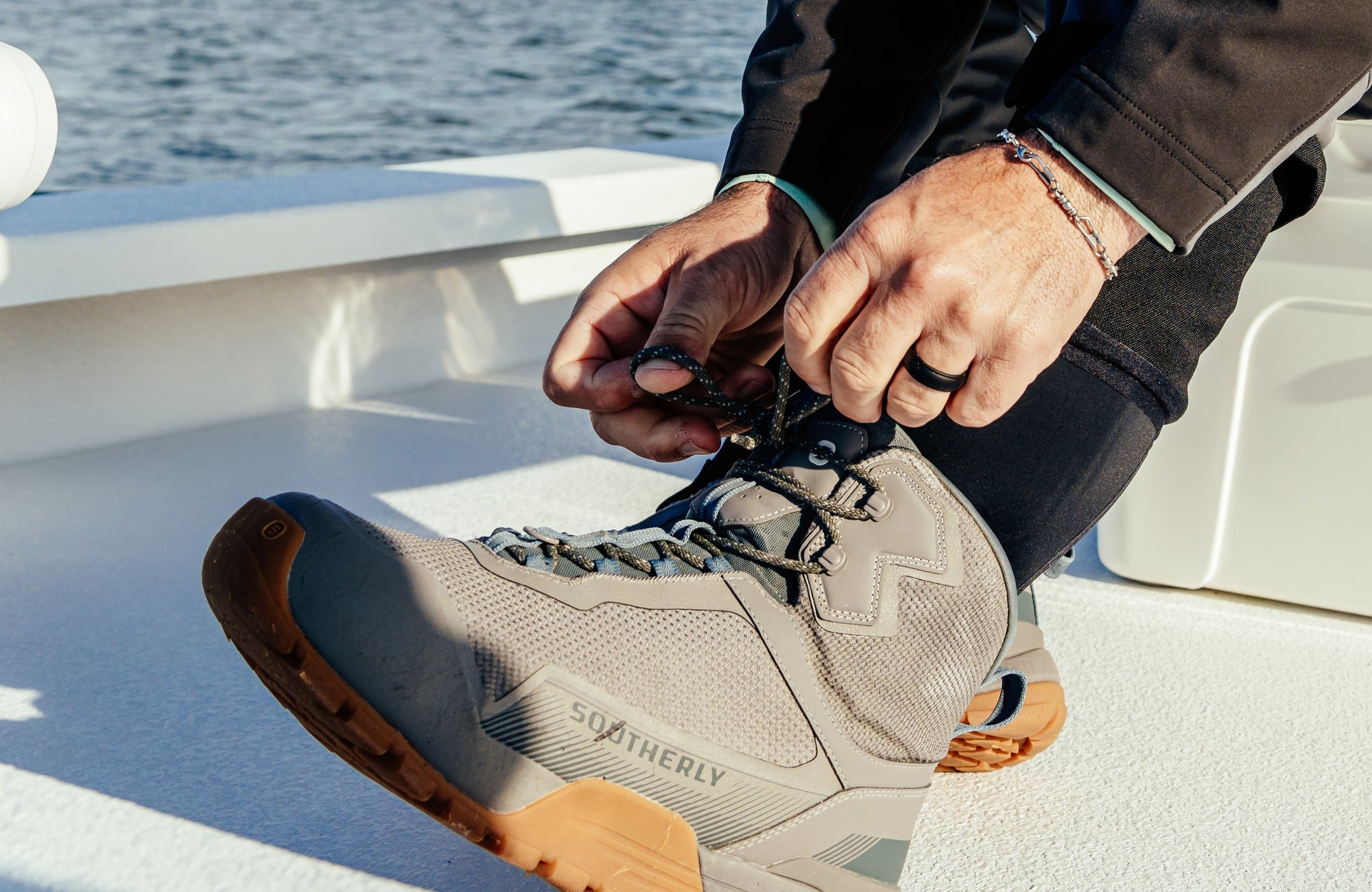 Lacing the Southerly Coastal Wading Boot on the boat deck