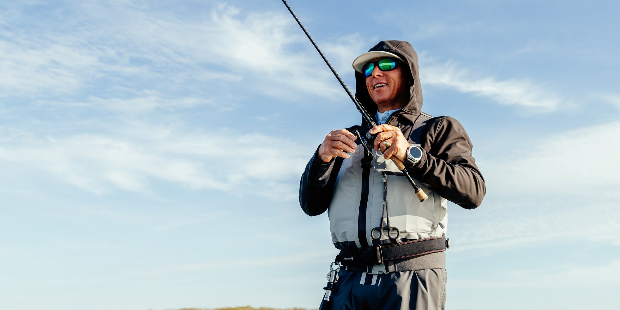 Angler casting in the Southerly Coastal Wader on a Texas flat