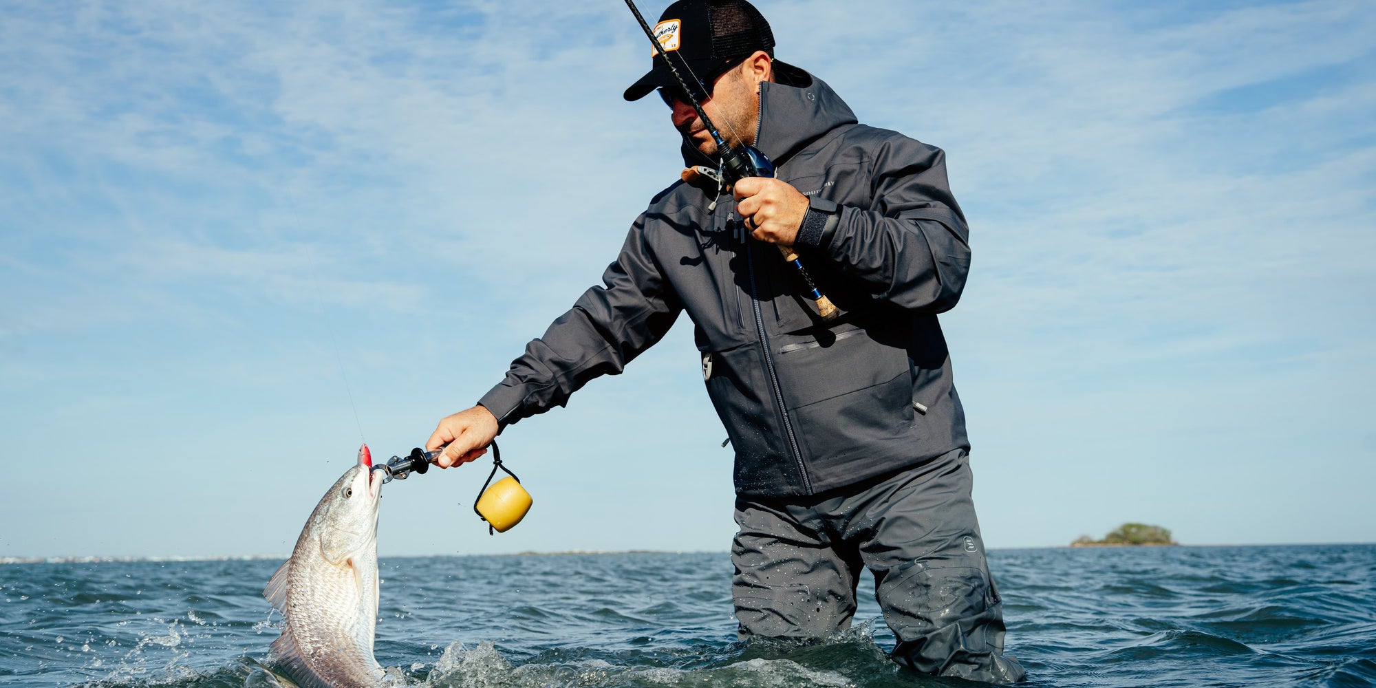 Landing a redfish in Southerly waders and jacket