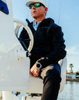 Men's Windward Thermal Hoody in Black, seated on the tower